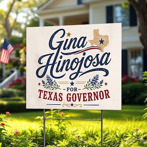 May include: A rectangular yard sign with a white background featuring the blue text Gina Hinojosa, a tan map of Texas with a blue star, blue floral accents, and the red text FOR TEXAS GOVERNOR, supported by two thin black metal stakes.