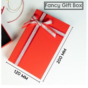 May include: A rectangular red gift box with a silver glitter ribbon bow on top. The box measures 200 mm by 120 mm. The text "Fancy Gift Box" is printed in a black rectangular frame at the top right corner of the image.