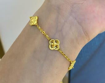 Bracciale a quadrifoglio in vero oro giallo 24 carati: gioielli da donna.