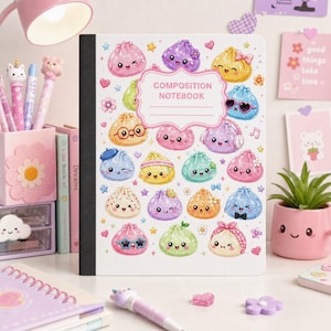 May include: A white composition notebook featuring a repeating pattern of colorful, smiling dumpling characters with various accessories like glasses, bows, and headphones. The center includes a pink-bordered label with the text COMPOSITION NOTEBOOK.