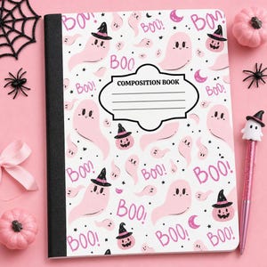 May include: A composition book with a white cover featuring a repeating pattern of light pink ghosts, jack-o'-lanterns wearing black witch hats, pink crescent moons, and the word "BOO!" in pink text. A central label reads "COMPOSITION BOOK."