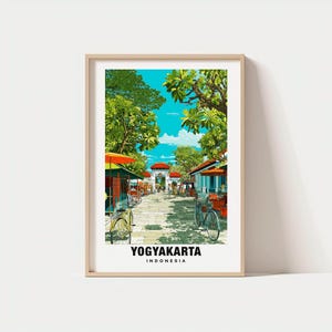 May include: A framed print featuring a vibrant street scene in Yogyakarta, Indonesia. The artwork showcases a sunny day with bicycles, market stalls, and lush green trees. The text "YOGYAKARTA INDONESIA" is displayed at the bottom.