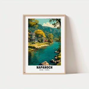 May include: A framed art print featuring a scenic view of Napanoch, New York. The artwork depicts a river flowing through a valley with houses and trees. The text "NAPANOCH NEW YORK" is printed at the bottom of the image.