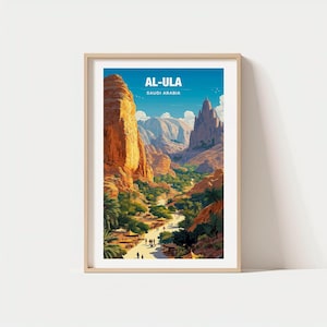 May include: A framed art print featuring a vibrant landscape of Al-Ula, Saudi Arabia. The artwork showcases towering rock formations in shades of orange and brown, a valley with lush greenery, and a clear blue sky. The text "AL-ULA SAUDI ARABIA" is displayed at the top.