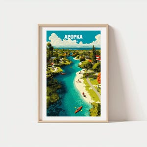 May include: Framed art print showing a colourful illustration of Apopka, with the city name in white block letters against a blue sky. The artwork depicts a river winding through a landscape with trees, people, and kayaks.