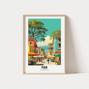 May include: A framed art print of a street scene in Fier, Albania. The artwork depicts colorful buildings, trees, and people walking along the street. The sky is a bright turquoise, and the print is framed in a light wood color.