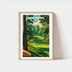 May include: Framed art print of a golf course scene. The artwork shows a green fairway, water, and trees. The text "AMEN CORNER GEORGIA" is at the top. The print is in a light wood frame, suitable for home decor.