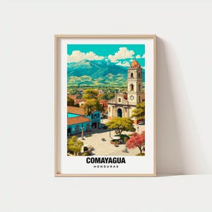 May include: A framed art print of Comayagua, Honduras. The artwork depicts a vibrant cityscape with a church tower, buildings, and mountains under a bright blue sky. The text "COMAYAGUA HONDURAS" is at the bottom.