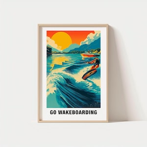 May include: A framed art print with a colourful illustration of wakeboarding. The image shows a person wakeboarding on a lake with a boat, a setting sun, and the text "GO WAKEBOARDING" at the bottom of the print.