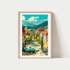 Könnte beinhalten: Ein gerahmter Kunstdruck mit einer lebendigen Illustration von Ifrane, Marokko. Das Kunstwerk zeigt eine malerische Stadtlandschaft mit farbenfrohen Gebäuden, roten Dächern und einem zentralen Brunnen. Der Himmel ist helltürkis, und die Berge sind im Hintergrund.