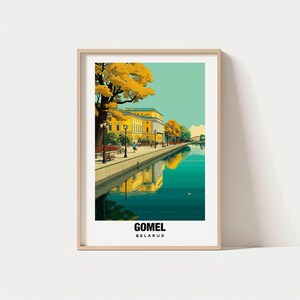 May include: A framed art print featuring a scenic view of Gomel, Belarus. The artwork depicts a yellow building reflected in a teal-colored river, with trees and a walkway along the water. The word "GOMEL" is printed at the bottom.