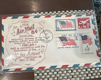 Sobre de correo aéreo de primera emisión de 1962, sello del aeropuerto de Dulles, sellos con la bandera estadounidense