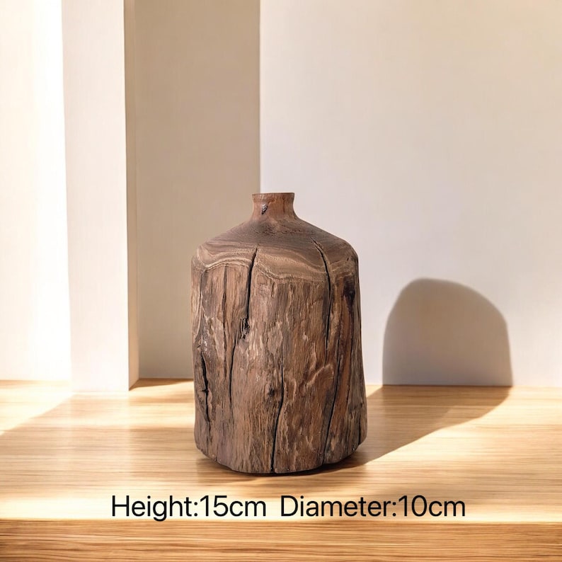 May include: A rustic wooden vase with a natural brown finish. The vase is 15cm tall and 10cm in diameter. It has a unique, organic shape and a rough, textured surface.