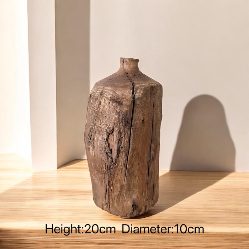 May include: A rustic wooden vase with a natural brown finish. The vase is 20 cm tall and 10 cm in diameter.  Height: 20cm Diameter: 10cm