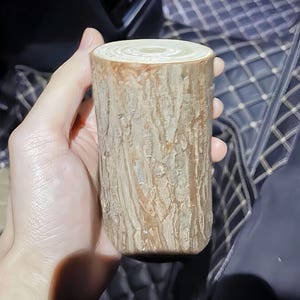 May include: A wooden log with a natural bark texture, perfect for crafting or decorating.
