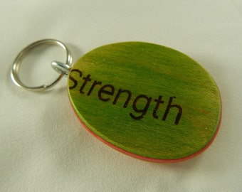 Strength Keychain made from a recycled skateboard deck