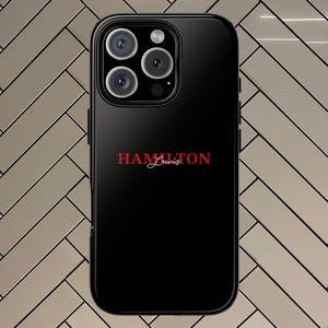 May include: Black phone case with a red "HAMILTON Lewis" logo.