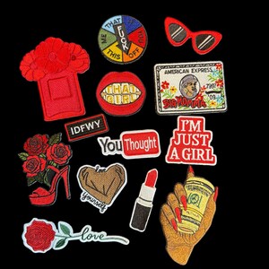 May include: A collection of embroidered patches with various designs. Includes a red lipstick, a high-heeled shoe with roses, a heart with the words "love yourself", and a patch that says "I'm just a girl".