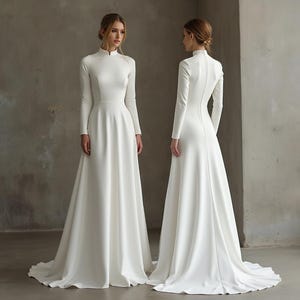 May include: A white, long-sleeved wedding dress with a high neckline and a flowing skirt. The dress is shown from the front and back, highlighting its elegant design. The fabric appears smooth and has a subtle sheen.