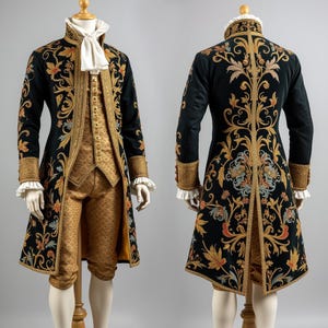 May include: A black velvet coat and breeches set with gold floral embroidery. The coat has a high collar, gold trim, and ruffled cuffs. The breeches are gold brocade. The outfit is displayed on a mannequin.