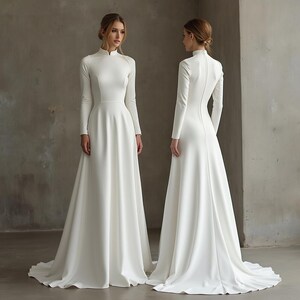 May include: A white, long-sleeved wedding dress with a high neckline and a flowing skirt. The dress is shown from the front and back, highlighting its elegant design. The fabric appears smooth and has a subtle sheen.