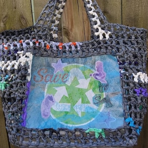 May include: A gray crocheted tote bag with a blue, green, and white design that says "Save Our Sea" with a recycling symbol and seahorse images. The bag is made from recycled plastic.