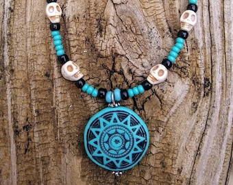 Faux Turquoise Sun glyph and white howlite skulls beaded necklace, Día de los Muertos theme