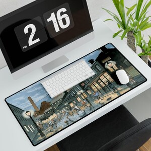May include: A rectangular desk mat featuring a historical street scene with figures in period clothing. The artwork depicts a nighttime battle scene with buildings, streetlights, and a smokestack. A white keyboard and mouse sit on the mat.