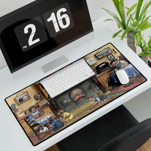 May include: A rectangular mousepad featuring a detailed illustration of a cozy, vintage kitchen scene. The artwork depicts people gathered around a fireplace and table, with a warm color palette and framed pictures on the wall. A white keyboard and mouse are on top.
