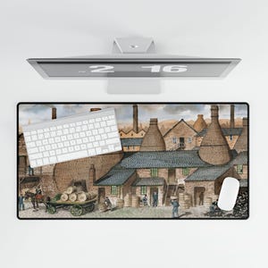 May include: A rectangular mouse pad featuring a vintage illustration of a brick industrial complex with tall chimneys and buildings. A white keyboard and mouse are on the pad. The image is set against a white background.