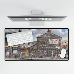 May include: A rectangular mouse pad featuring a watercolor painting of a brick building with a Heinz Tomato Ketchup sign. Children are playing in the street. A white keyboard and mouse are on the pad.