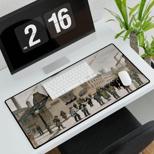 May include: A rectangular mouse pad featuring a vintage street scene with figures in coats and hats. The artwork is in muted tones of brown, gray, and beige. A white keyboard and mouse sit on the pad, with a computer monitor and plant in the background.