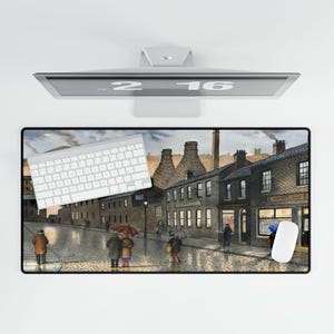 May include: A rectangular mouse pad featuring a watercolor painting of a rainy street scene with brick buildings, people with umbrellas, and a keyboard. The color palette includes grays, browns, and muted tones.