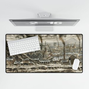 May include: A rectangular mousepad featuring a vintage industrial town scene with smoking chimneys and buildings. A white keyboard and mouse are on the pad. A computer monitor displays the date 2-16.