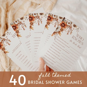 May include: A set of white bridal shower game cards featuring a floral border of orange, brown, and white flowers. The cards include the text Who Knows the Bride Best and Fill in the Blanks, with numbered lists of questions and blank lines for writing answers.