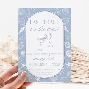 May include: A light blue invitation with a seashell pattern and the text "LAST TOAST on the coast". The invitation includes the names "mary kate" and the date "SEPTEMBER 18, 2025".