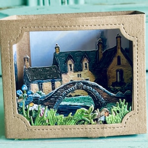 Scatola diorama in carta con scena di campagna inglese d'epoca.