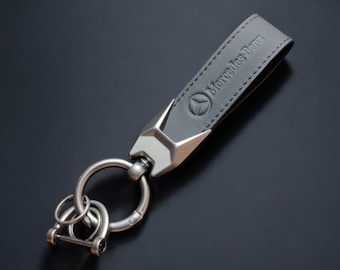 Mercedes Benz key fob in black leather and featuring the Mercedes Benz logo.