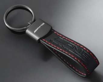 Mercedes AMG key ring with AMG logo in black with red stitching.
