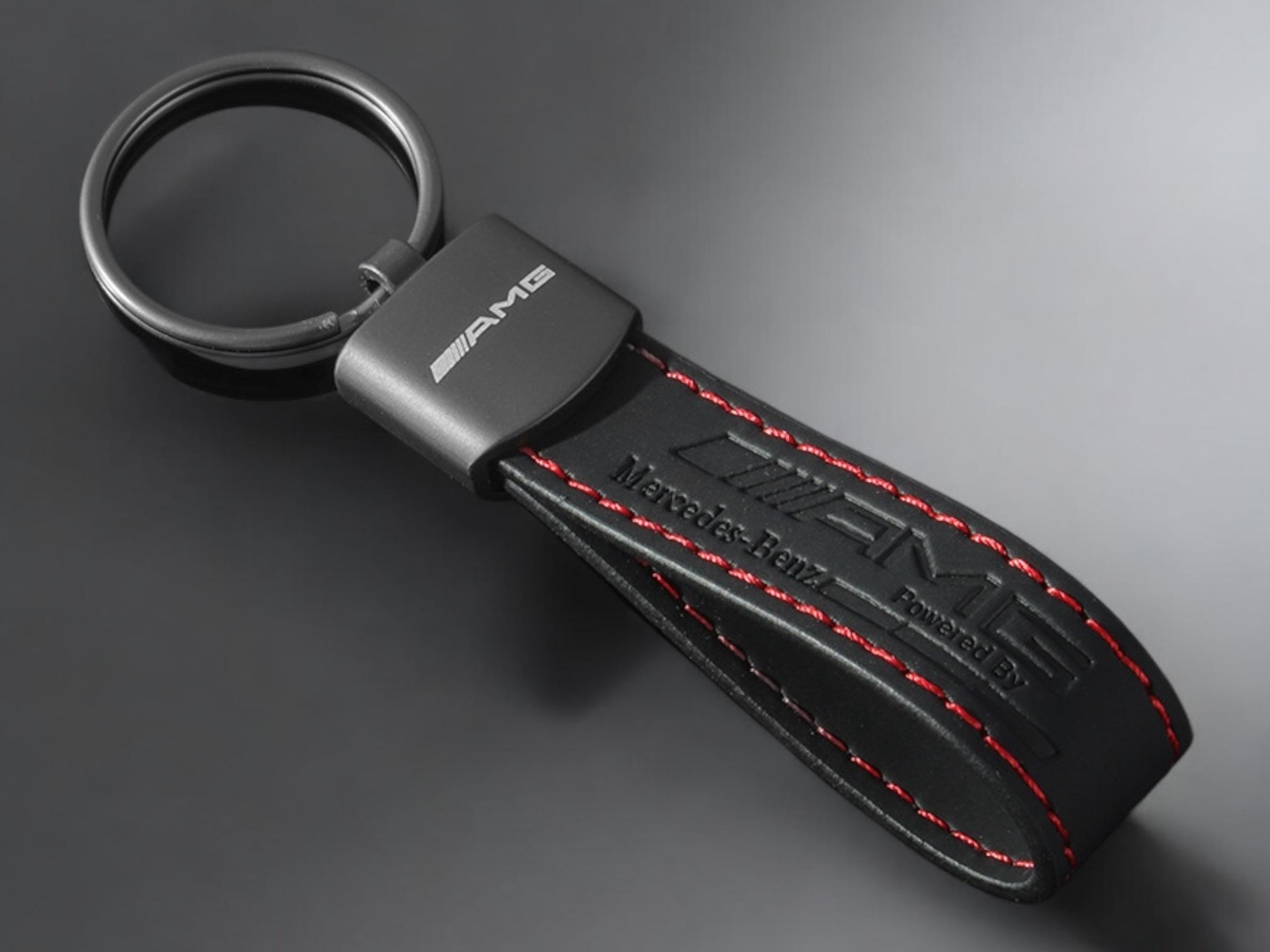 Mercedes AMG key ring with AMG logo in black with red stitching.