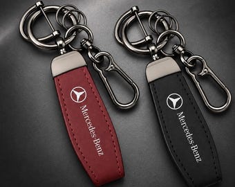 Mercedes Benz key fob in black and red leather and featuring the Mercedes Benz logo.