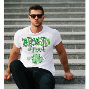 May include: White t-shirt with green and white text that reads "PHYSIO Squad O'Malley" with a green shamrock.