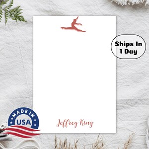 May include: White notepad with a red gymnast silhouette, the text "Jeffrey King" and a "Made in USA" sticker.