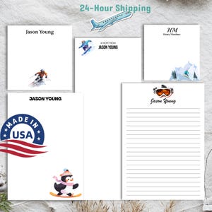 May include: Four different designs of personalized stationery featuring winter sports themes. The designs include a skier, a snowboarder, a penguin on skis, and a pair of ski goggles. The stationery is white with black text and a black border. The text on the stationery reads "Jason Young" and "A Note From Jason Young".