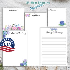 May include: Four personalized notepads with a floral design. The notepads feature the names "Ronald Hall", "Betty Wilson", "Henay Martinez", and "Henry Martinez". The notepads are decorated with a blue and purple floral design. The notepads are made in the USA.