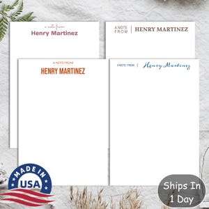 May include: A set of three notepads with a white background and a header that says "A Note From Henry Martinez". The header is in different colors and fonts on each notepad. The notepads are on a white surface.