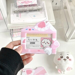 May include: A pink and white member's card holder with a cartoon bear illustration. The holder has a house-shaped design with a strawberry and cloud motif. The text "MEMBER'S CARD" is visible, along with Japanese text.
