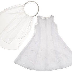 May include: White tulle dress with a white tulle veil and a silver headband. The dress has a sleeveless design and a full skirt.