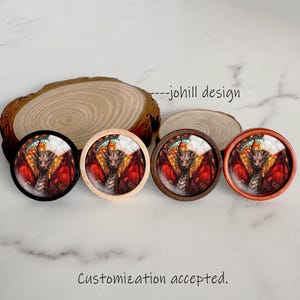 May include: Four round decorative cabinet knobs with a stained glass dragon design. The knobs have black, natural wood, and brown frames. The text "--johill design" and "Customization accepted" are also visible.