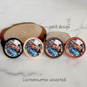 May include: Four round decorative knobs with a dragon design in stained glass style. The knobs have black, natural wood, dark brown, and reddish-brown frames. The text "--johill design" and "Customization accepted" are also visible.